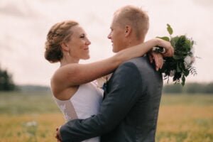 trouwfotograaf elkaar aankijkend in weiland Tuusula Finland