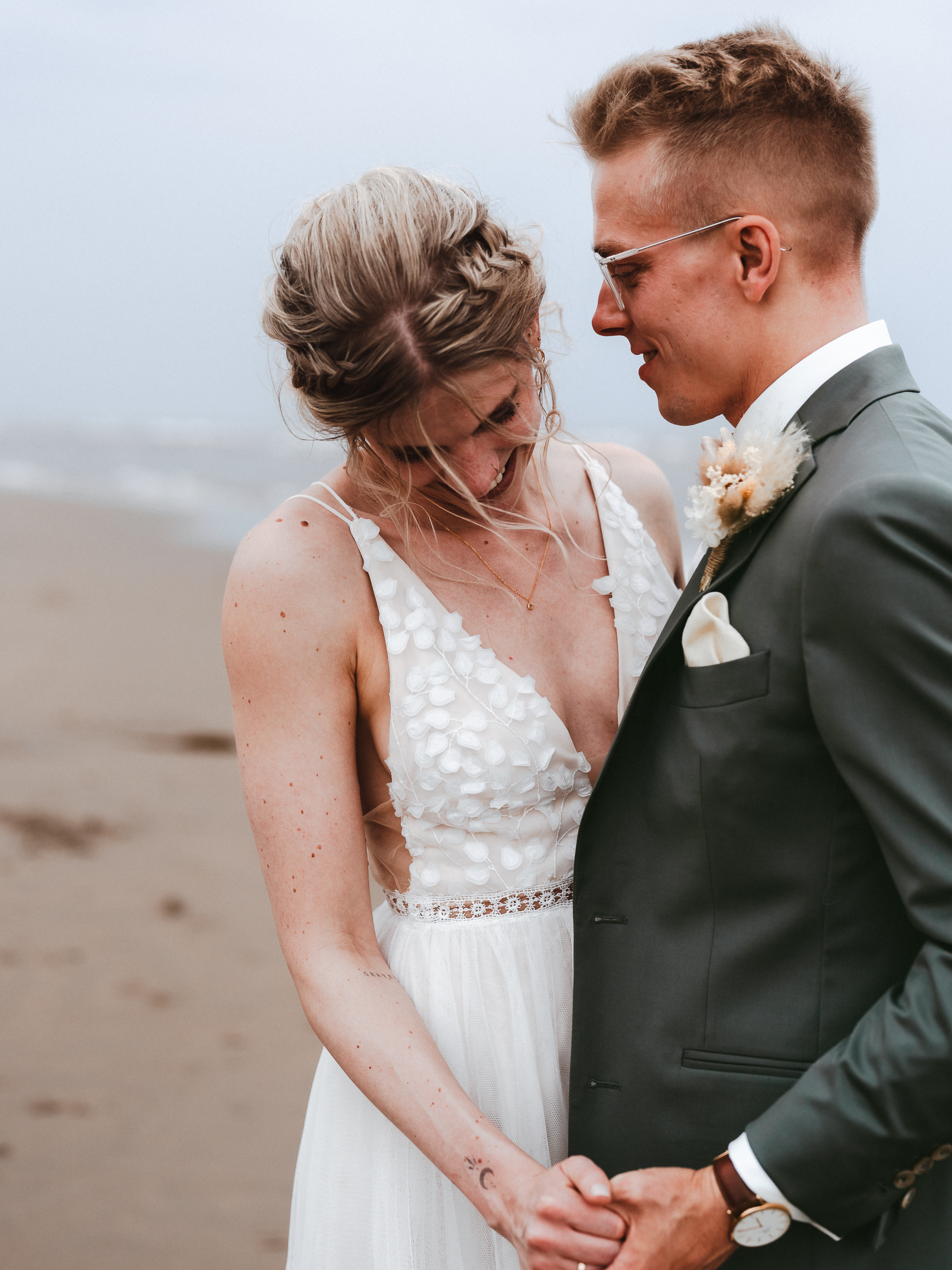International couple enjoying a relaxed evening photoshoot at the beach in Noordwijk aan Zee, captured by Photos by Ville, wedding photographer in the Netherlands for expats and international couples