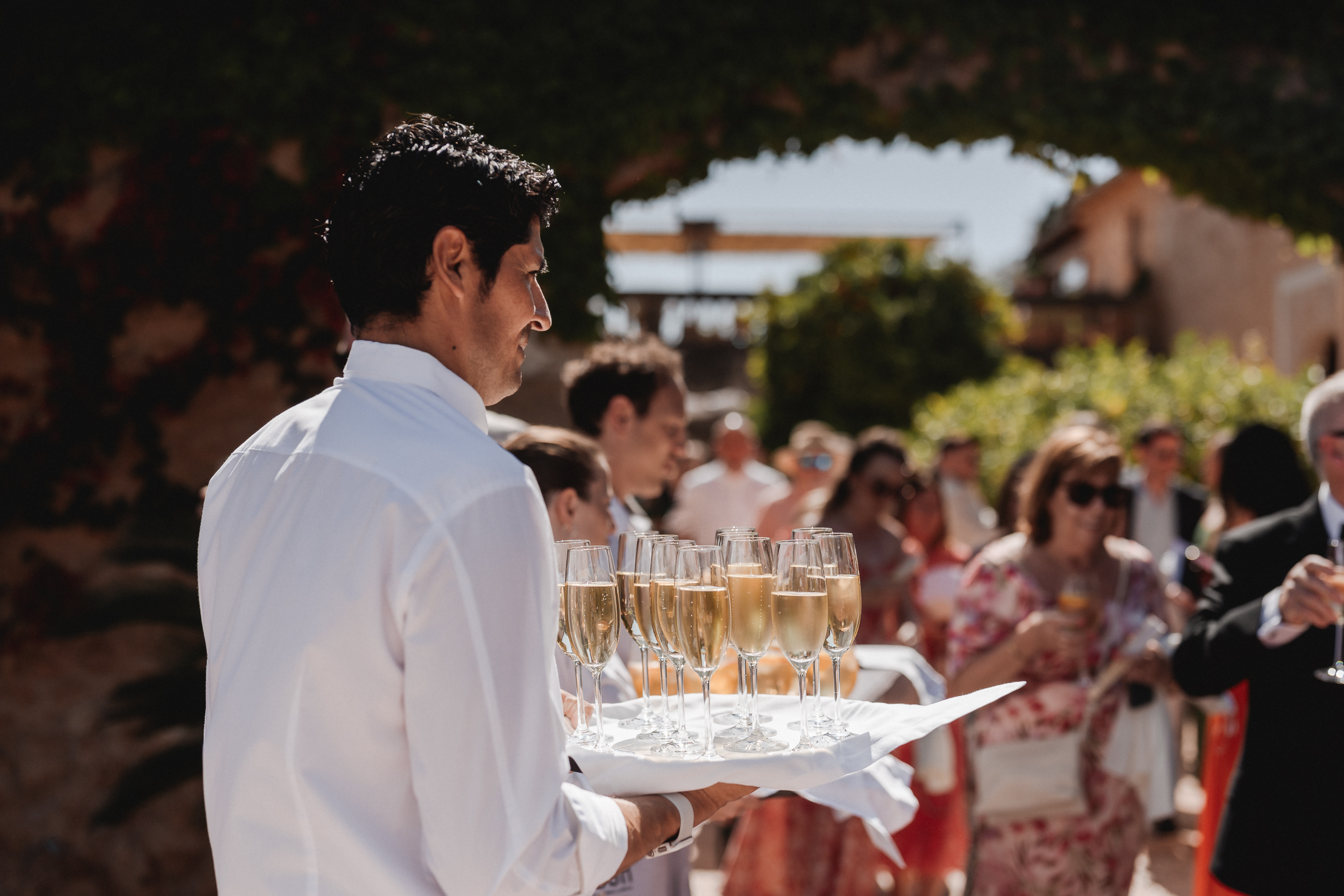 Fosh Catering staff serving champagne to guests during wedding reception at Finca Son Mir Mallorca