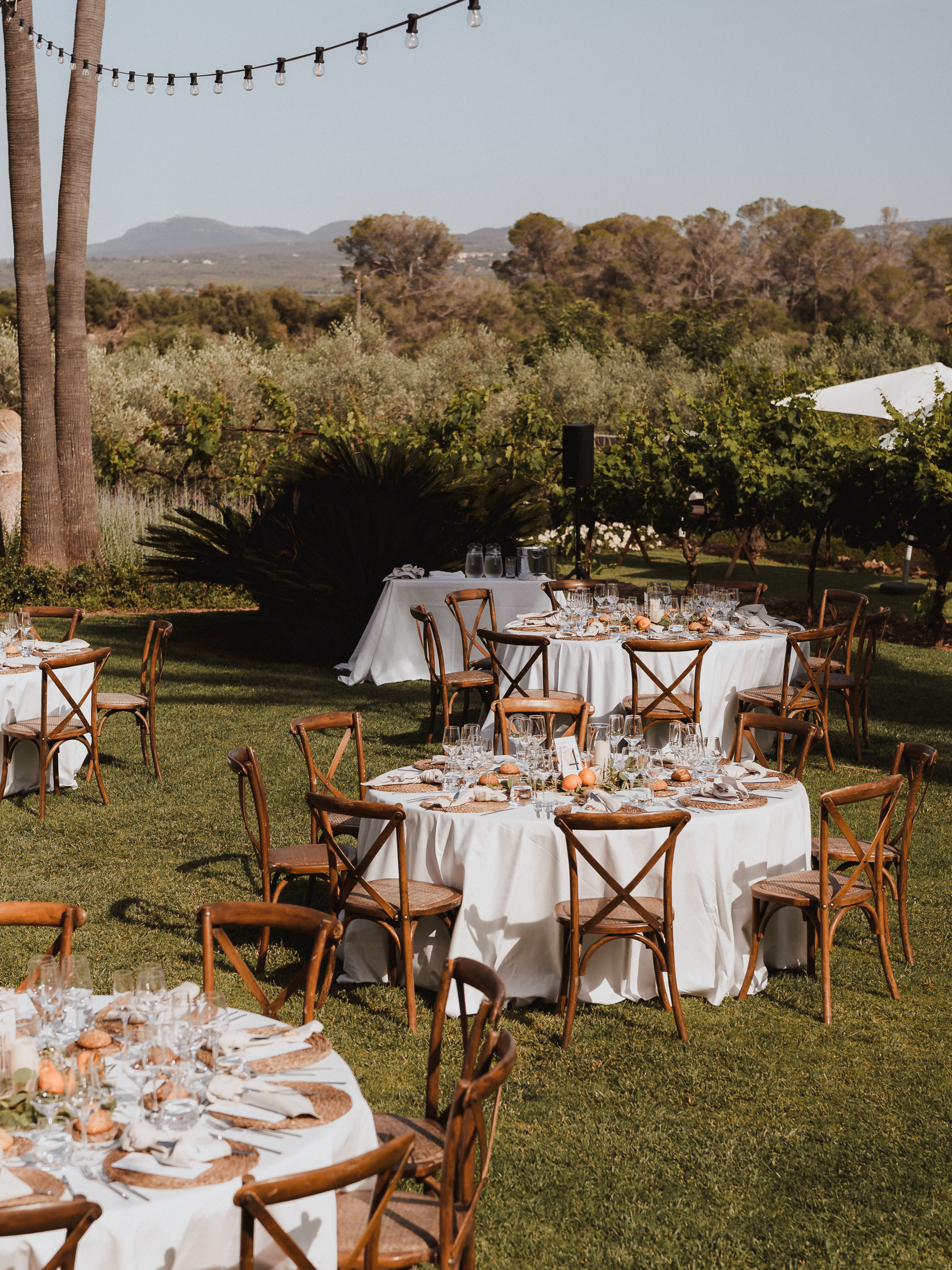 Wide view of wedding dinner tables in the garden of Finca Son Mir Mallorca