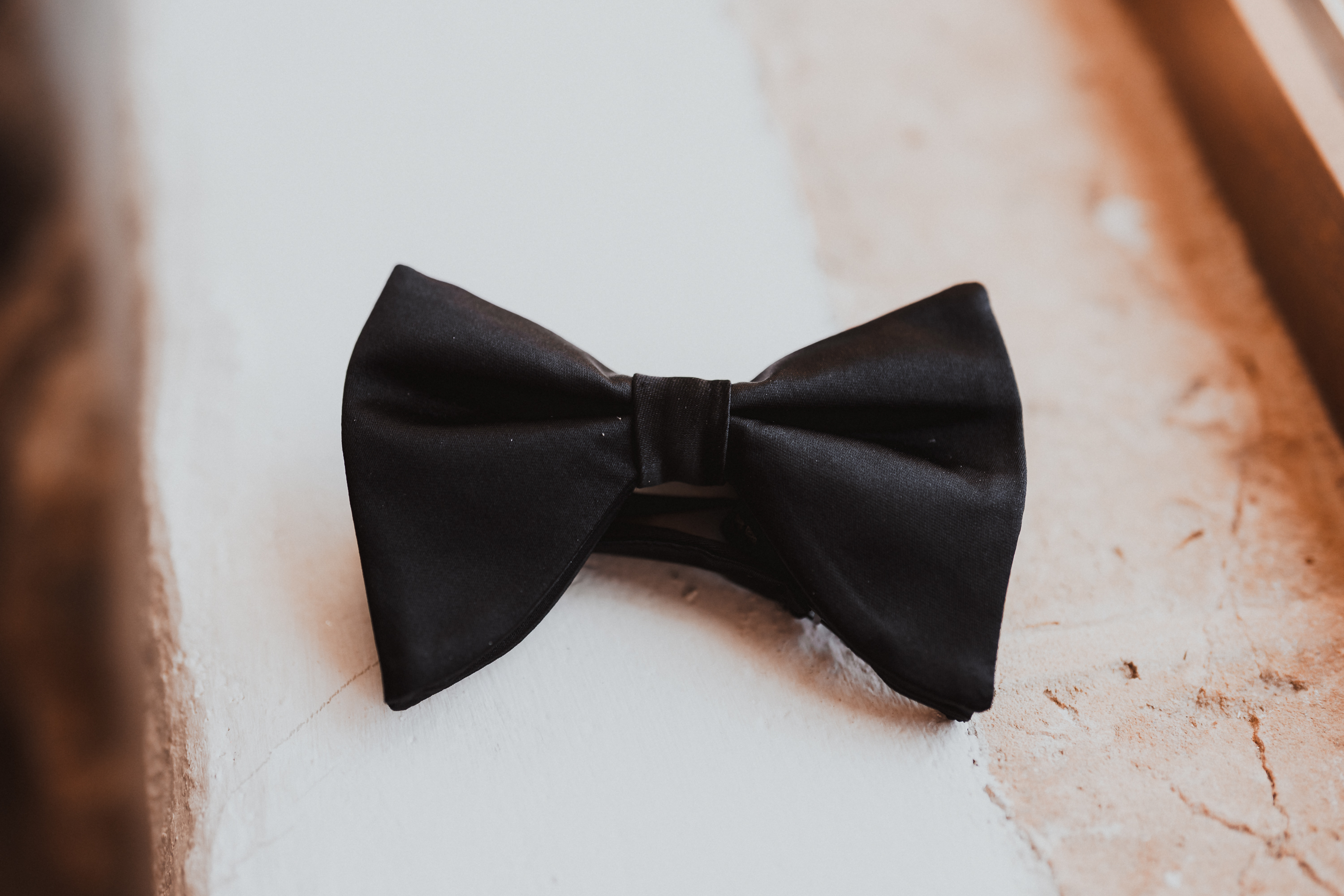 Close-up of a groom’s bow tie during wedding preparations at Finca Son Mir