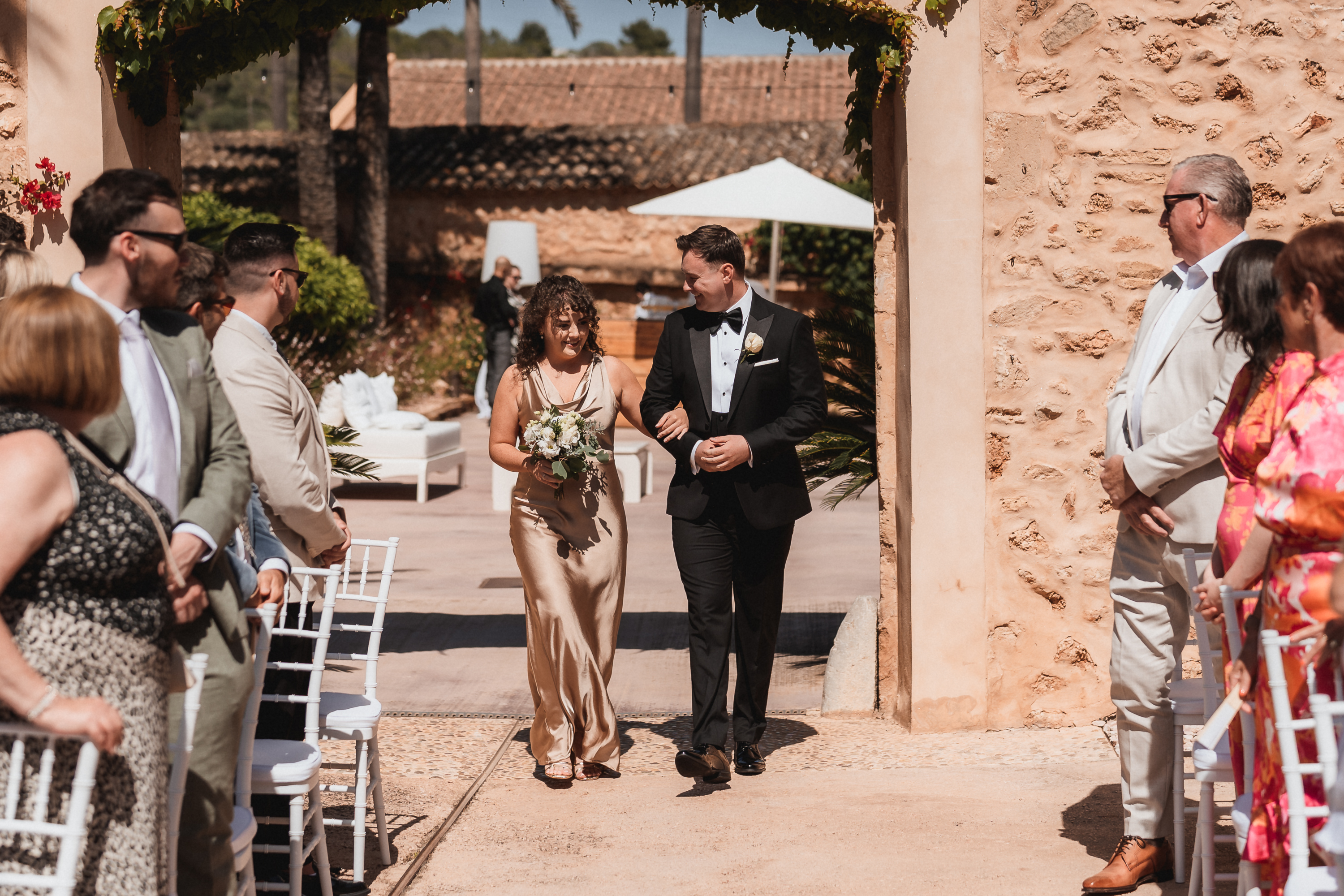 Groom walking into ceremony with his sister at Finca Son Mir Mallorca