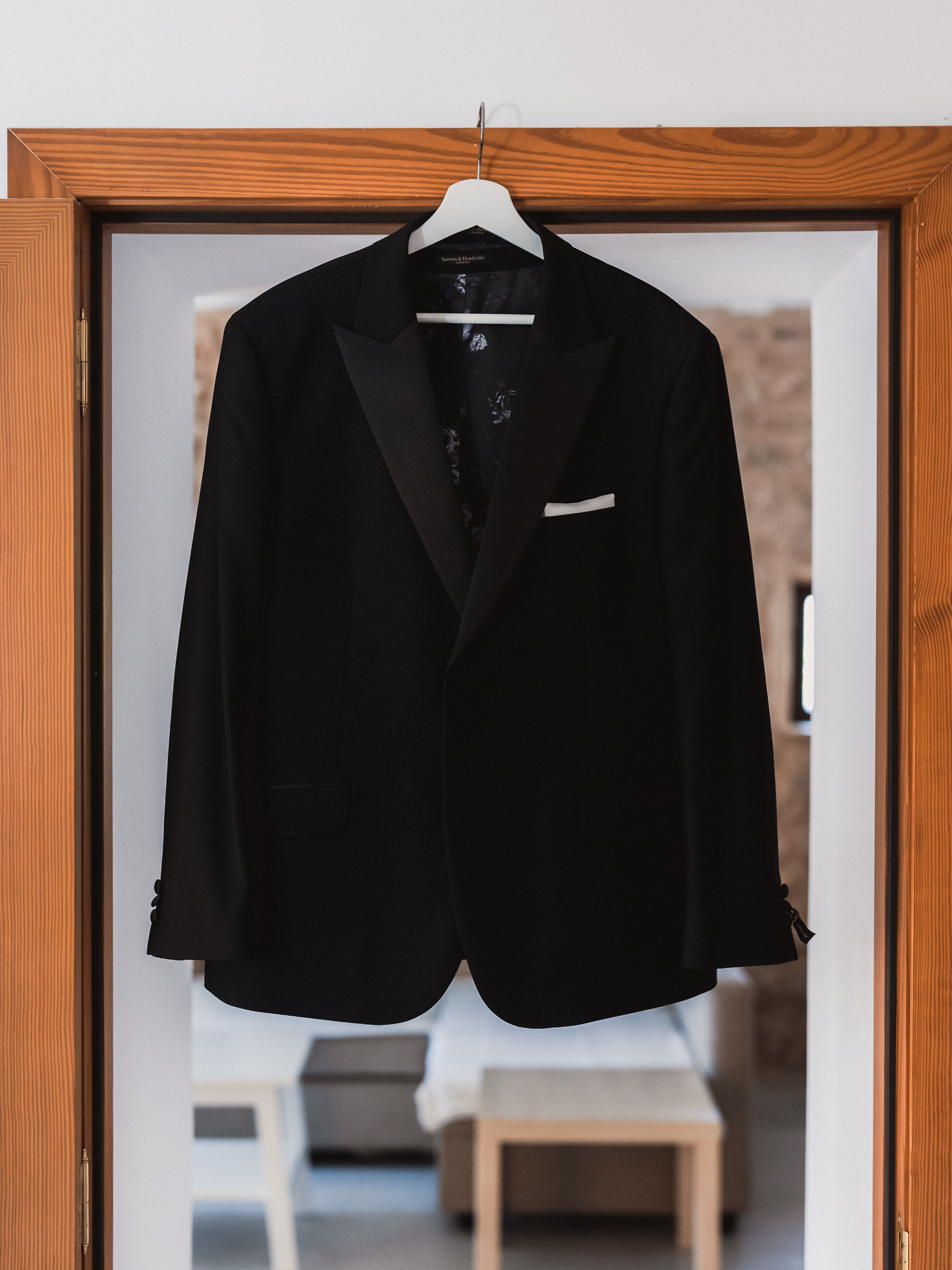 Wedding suit hanging in a doorway at Finca Son Mir before a Mallorca wedding photographed by Photos by Ville
