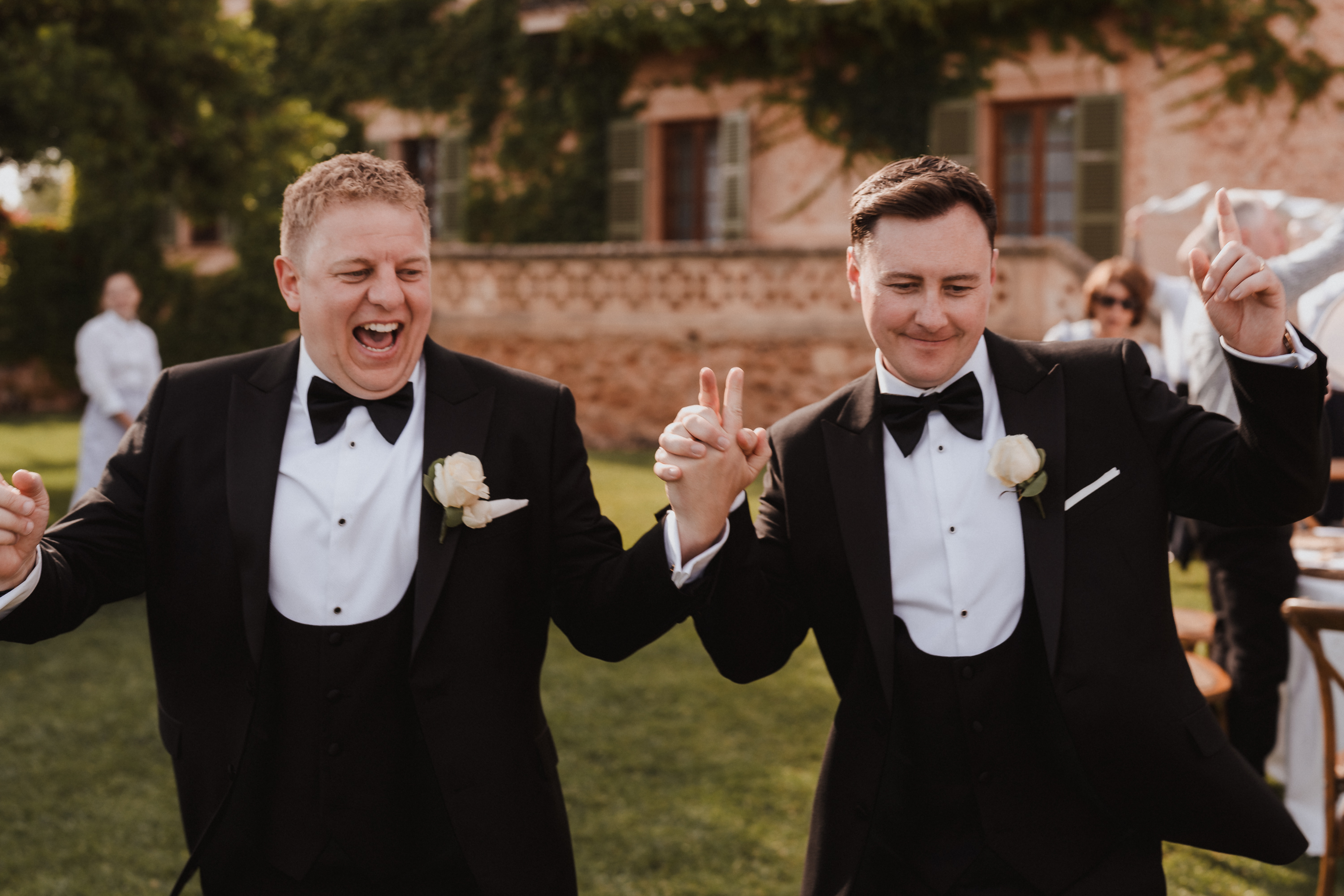 Two grooms entering wedding dinner with music at Finca Son Mir Mallorca photographed by Photos by Ville