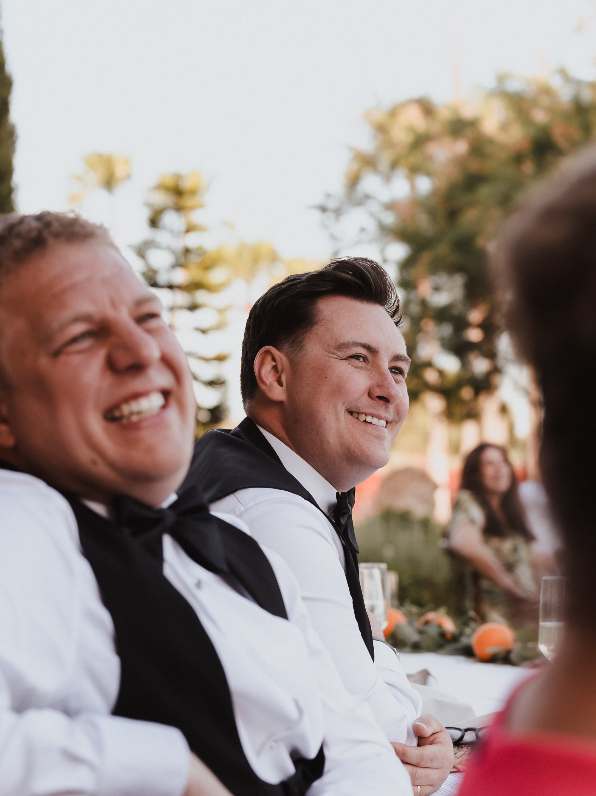 Two grooms listening to speeches during their wedding dinner at Finca Son Mir Mallorca photographed by Photos by Ville