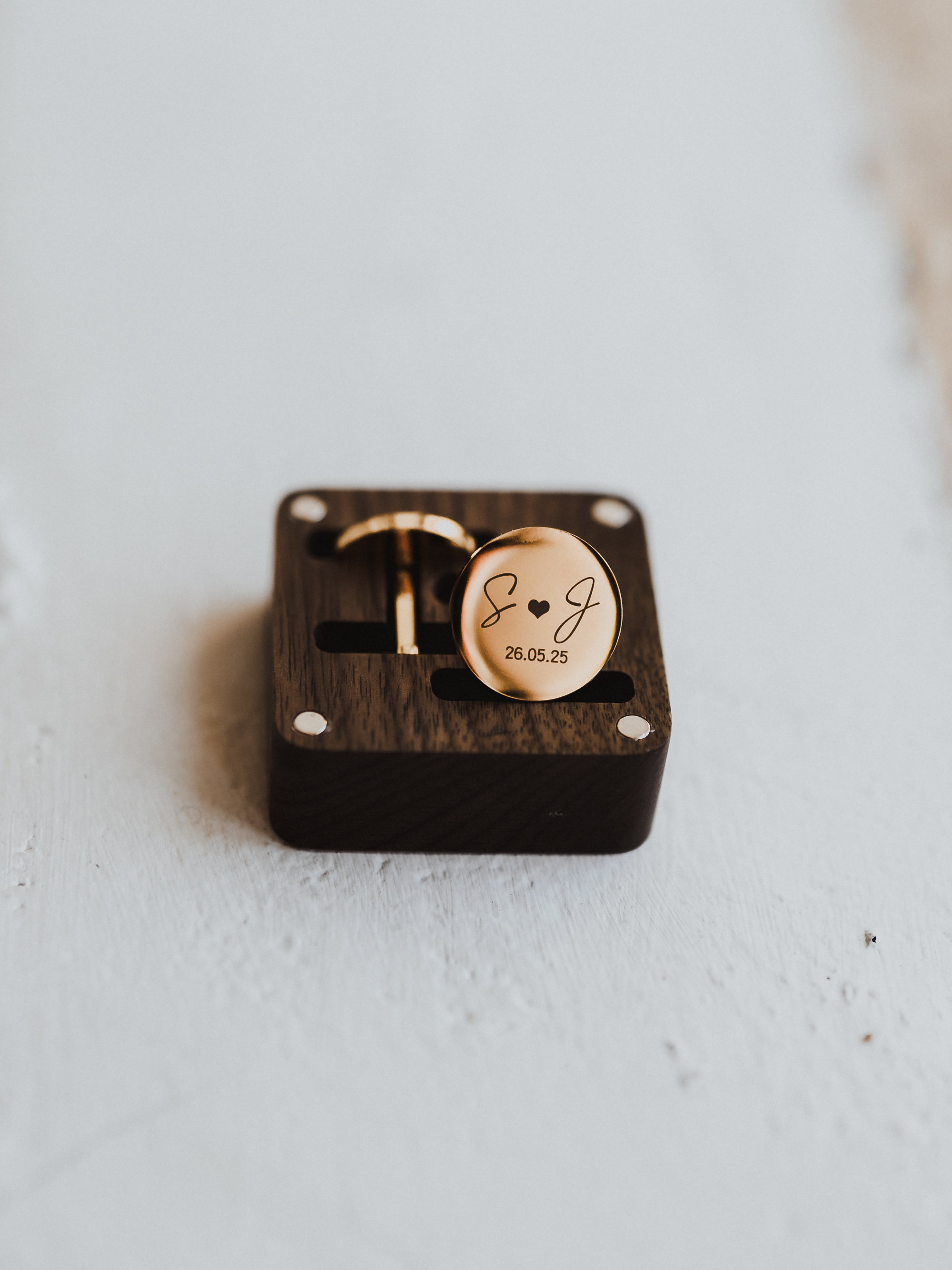 Close-up of personalised cufflinks with initials for a groom at a Mallorca wedding